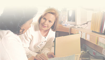 Two nurses at nursing station.